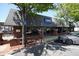 Restaurant featuring large windows, a brick facade, and outdoor seating in a bustling urban setting at 110 Barnesdale Ter, Woodstock, GA 30188
