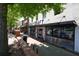 Modern storefront with a brick facade, large display windows, and outdoor seating along a tree-lined street at 110 Barnesdale Ter, Woodstock, GA 30188