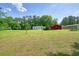 A well-maintained yard features a small house and a red barn-like structure at 110 Barnesdale Ter, Woodstock, GA 30188