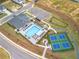 This aerial view shows the community clubhouse, pool, and pickleball courts, nestled in a park-like setting at 3462 Fishpond Cir, Dacula, GA 30019