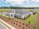 Community building with a pool and lounging area with green spaces, street and parking at 3462 Fishpond Cir, Dacula, GA 30019