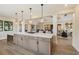 An open, spacious kitchen with a large island and stainless steel appliances with lighting at 3462 Fishpond Cir, Dacula, GA 30019