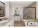 This bathroom has a granite countertop, framed mirror, and glass shower with a soaking tub at 3585 Adelaide Xing, Brookhaven, GA 30319
