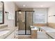 This bathroom has a granite countertop, framed mirror, and glass shower with a soaking tub at 3585 Adelaide Xing, Brookhaven, GA 30319