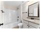 Bright bathroom featuring a shower and tub combination with granite countertops and dark bronze fixtures at 3585 Adelaide Xing, Brookhaven, GA 30319