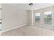 This bedroom offers plush carpeting and two windows that provide natural light and outdoor views at 3585 Adelaide Xing, Brookhaven, GA 30319