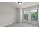 This bedroom has neutral colored carpet and two windows to let in natural light at 3585 Adelaide Xing, Brookhaven, GA 30319