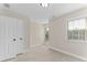 Carpeted bedroom with two windows, white walls, and white doors at 3585 Adelaide Xing, Brookhaven, GA 30319