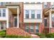 Charming brick townhome with steps leading to a welcoming entrance and well-maintained landscaping at 3585 Adelaide Xing, Brookhaven, GA 30319