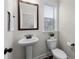 A quaint half bathroom with pedestal sink and classic fixtures at 3585 Adelaide Xing, Brookhaven, GA 30319
