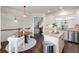 Bright kitchen with white cabinets, stainless steel appliances, granite countertops, and seamless access to the dining area at 3585 Adelaide Xing, Brookhaven, GA 30319