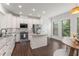 Well-lit kitchen with stainless steel appliances, granite countertops, a center island, and hardwood floors at 3585 Adelaide Xing, Brookhaven, GA 30319