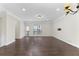 Spacious living room with hardwood floors, modern lighting, and crown molding, ideal for entertaining guests at 3585 Adelaide Xing, Brookhaven, GA 30319