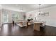 Bright living and dining area featuring hardwood floors, neutral paint, modern furniture, and ample natural light at 3585 Adelaide Xing, Brookhaven, GA 30319