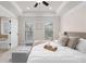Bright primary bedroom featuring tray ceiling and a sitting area at 3585 Adelaide Xing, Brookhaven, GA 30319