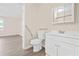 Bathroom featuring laminate wood flooring, a modern vanity and an ADA compliant toilet at 3698 Fairlane Nw Dr, Atlanta, GA 30331