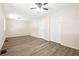 Spacious bedroom with laminate wood floors, a ceiling fan and a closet with sliding doors at 3698 Fairlane Nw Dr, Atlanta, GA 30331