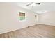 Large bedroom with wood-look laminate flooring, two windows, and a ceiling fan at 3698 Fairlane Nw Dr, Atlanta, GA 30331