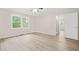 Large bedroom with laminate flooring, ceiling fan, and an open doorway to another room at 3698 Fairlane Nw Dr, Atlanta, GA 30331