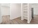 Hallway with shelves provides access to kitchen on one side and bathroom to the other at 3698 Fairlane Nw Dr, Atlanta, GA 30331