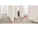 Hallway view of shelves next to the open kitchen and the bathroom beyond at 3698 Fairlane Nw Dr, Atlanta, GA 30331