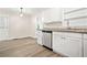Bright kitchen with stainless steel dishwasher and white cabinets and dining area at 3698 Fairlane Nw Dr, Atlanta, GA 30331