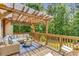 Inviting back deck area with a pergola, cozy furniture, and a view of the lush backyard at 3835 Annandale Ln, Suwanee, GA 30024