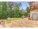 Expansive stone patio with a lush backyard, volleyball net, and views of the deck at 3835 Annandale Ln, Suwanee, GA 30024