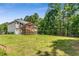 Large backyard with lush grass, a volleyball net, play set, and a deck perfect for recreation and relaxation at 3835 Annandale Ln, Suwanee, GA 30024