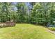 Well-maintained backyard with lush green grass, mature trees, and a playground, ideal for outdoor activities at 3835 Annandale Ln, Suwanee, GA 30024