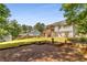 Spacious backyard with a deck, lush green lawn, and decorative garden at 3835 Annandale Ln, Suwanee, GA 30024