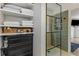 Bathroom with open closet and shelving, leading to the glass walk-in shower at 3835 Annandale Ln, Suwanee, GA 30024