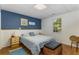 This bedroom features a decorative accent wall, hardwood floors and a large window for natural light at 3835 Annandale Ln, Suwanee, GA 30024