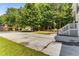 Wide driveway leading to the house, framed by mature trees and a green lawn at 3835 Annandale Ln, Suwanee, GA 30024