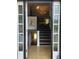 Inviting home foyer with hardwood floors, staircase, and decorative lighting at 3835 Annandale Ln, Suwanee, GA 30024