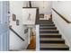 Bright home foyer featuring a staircase, hardwood floors, and neutral decor at 3835 Annandale Ln, Suwanee, GA 30024