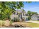 View of the home with stone accent and front yard with natural landscaping features at 3835 Annandale Ln, Suwanee, GA 30024