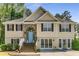 Charming two-story home featuring a stone archway and a light blue front door at 3835 Annandale Ln, Suwanee, GA 30024