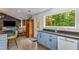 Open kitchen flows into the living area, featuring granite countertops and modern appliances at 3835 Annandale Ln, Suwanee, GA 30024