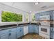 Bright kitchen featuring blue cabinets, granite countertops, and natural light at 3835 Annandale Ln, Suwanee, GA 30024