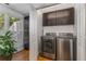 This laundry room has an LG washer and dryer, a large window and plenty of storage at 3835 Annandale Ln, Suwanee, GA 30024