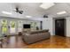 Bright living room with hardwood floors, modern ceiling fans, and sliding glass doors to the exterior at 3835 Annandale Ln, Suwanee, GA 30024