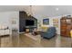 Open concept living room with a stylish accent wall, comfortable seating, and ample natural light at 3835 Annandale Ln, Suwanee, GA 30024