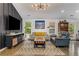 Bright living room featuring hardwood floors, stylish furnishings, and a modern light fixture at 3835 Annandale Ln, Suwanee, GA 30024