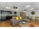 Open-concept living room and kitchen area with modern finishes and a comfortable sectional sofa at 3835 Annandale Ln, Suwanee, GA 30024