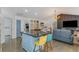 Open-concept living area with a kitchen island and access to the living room at 3835 Annandale Ln, Suwanee, GA 30024