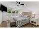 Cozy main bedroom featuring a plush bed, dark hardwood floors, and ample natural light at 3835 Annandale Ln, Suwanee, GA 30024