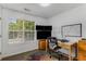 This office offers a large window, natural wood flooring and a built-in desk and file cabinet at 3835 Annandale Ln, Suwanee, GA 30024