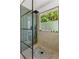 Walk-in shower with a modern design, a rainfall showerhead, and a window for natural light at 3835 Annandale Ln, Suwanee, GA 30024