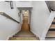 View down the home staircase with wood flooring and a glimpse of the entry hall at 3835 Annandale Ln, Suwanee, GA 30024